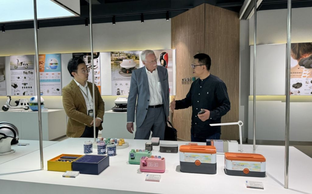 People engaged in conversation at an exhibition.