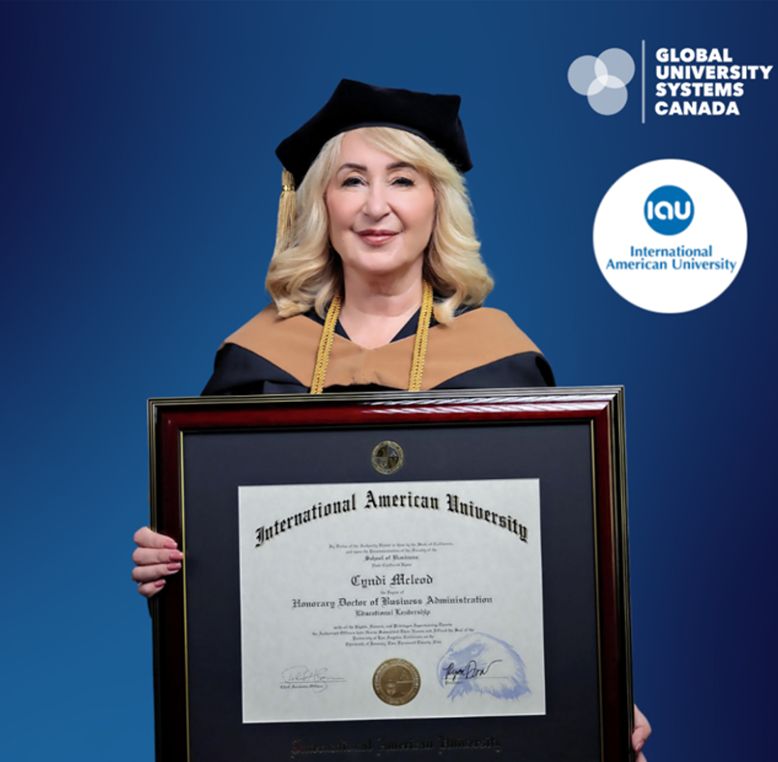 Cyndi McLeod poses with her honorary doctorate in Business Administration for Educational Leadership diploma.