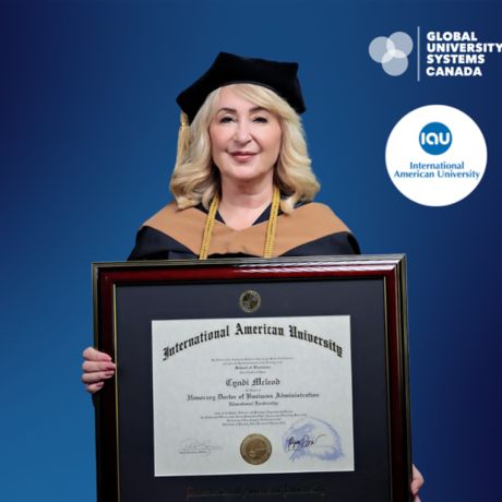 Cyndi McLeod poses with her honorary doctorate in Business Administration for Educational Leadership diploma.