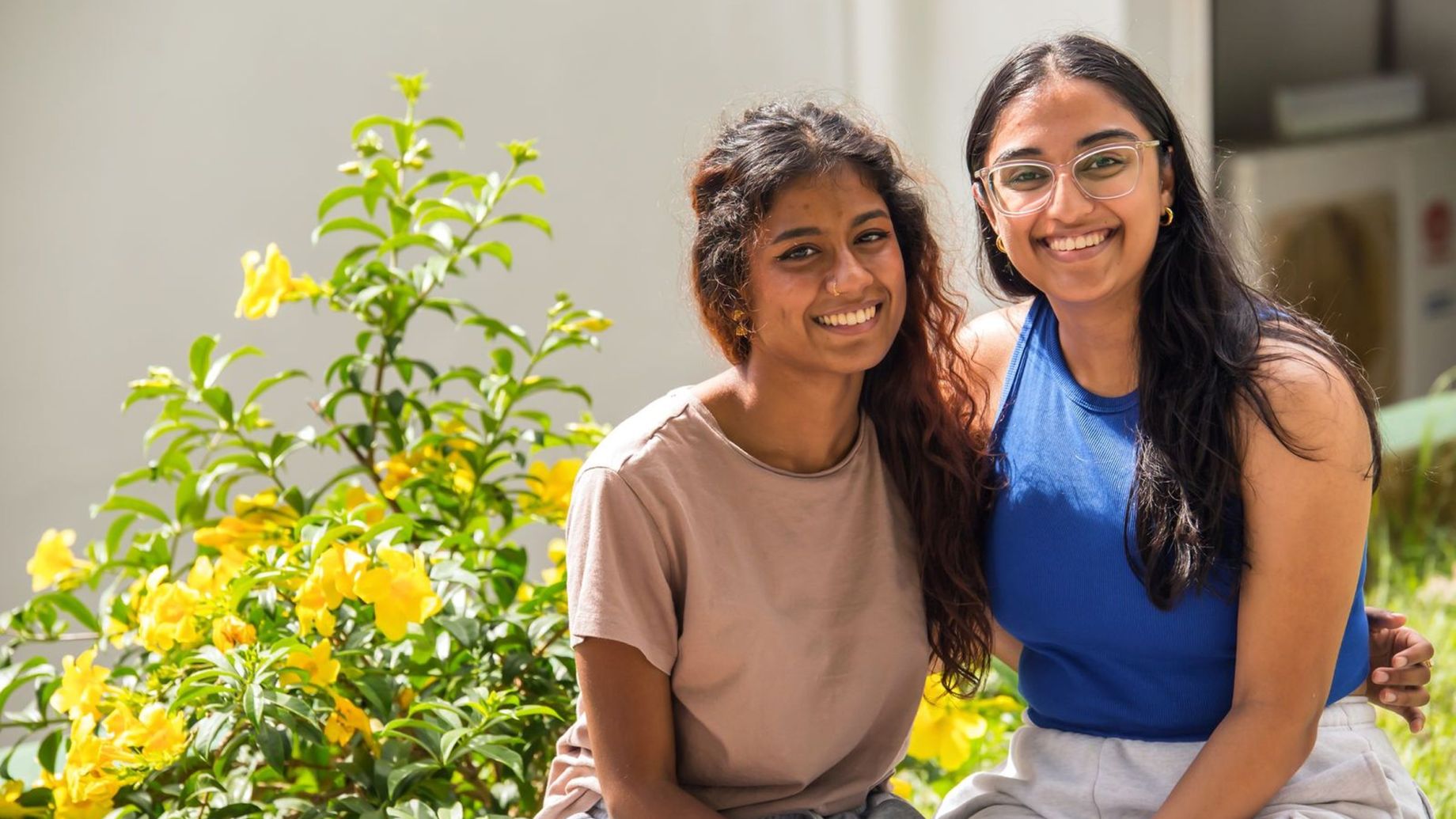 Two students smiling.