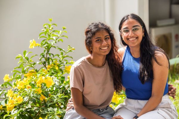 Two students smiling.