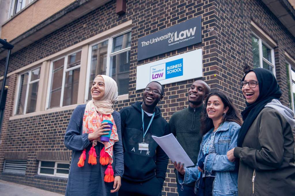 A group of diverse students outside the University of Law campus