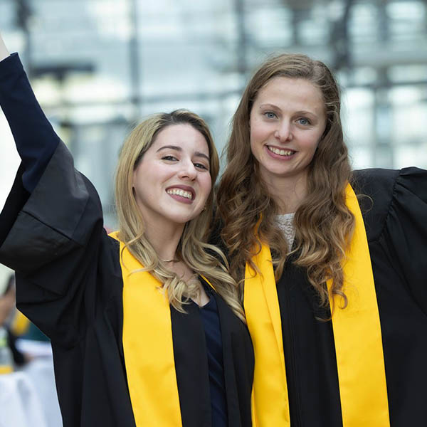 Two students celebrating their graduation