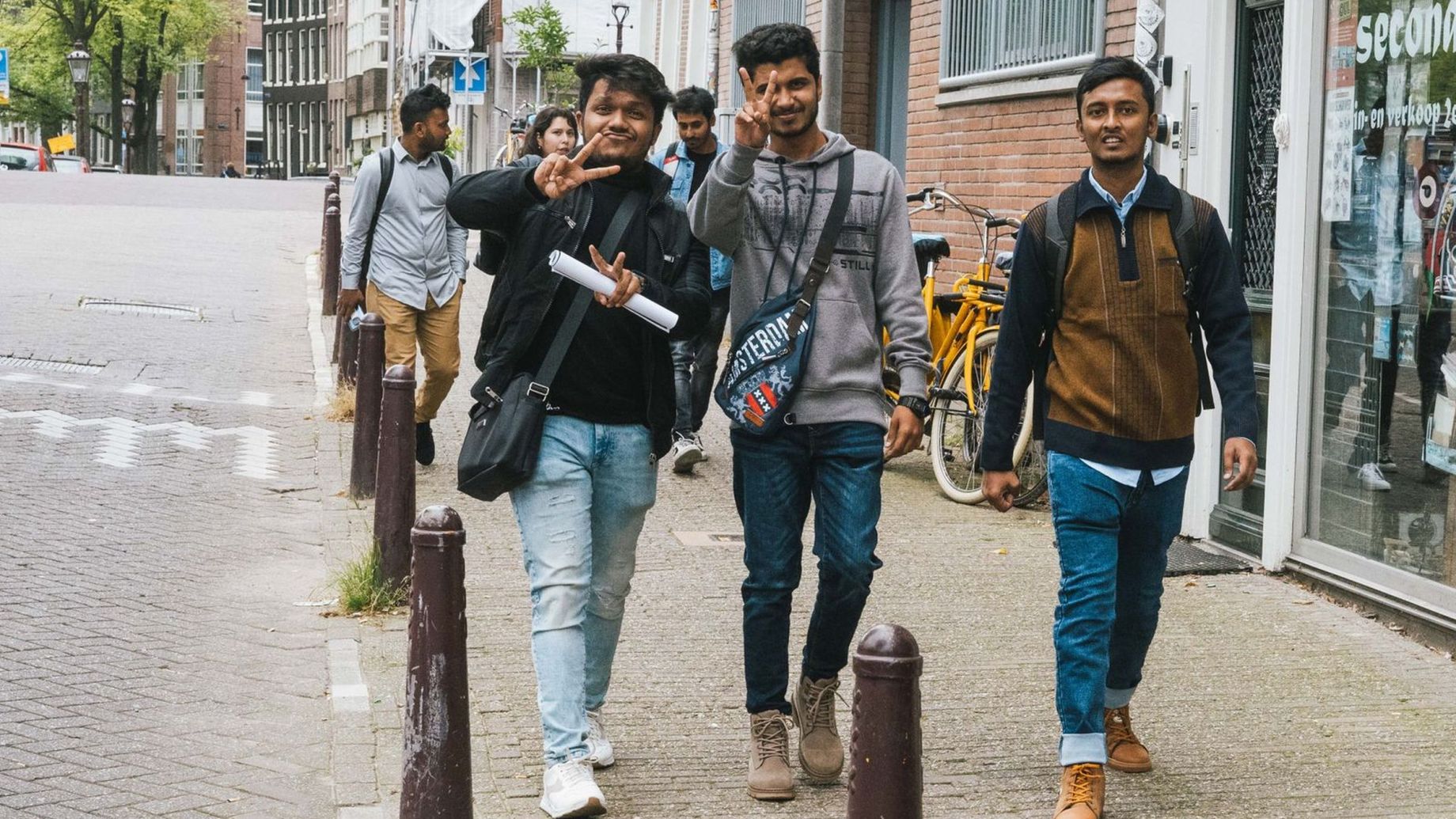 A group of diverse students walking down the street