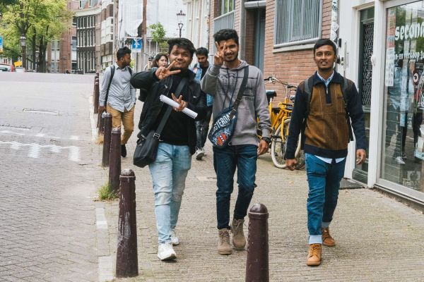 A group of diverse students walking down the street