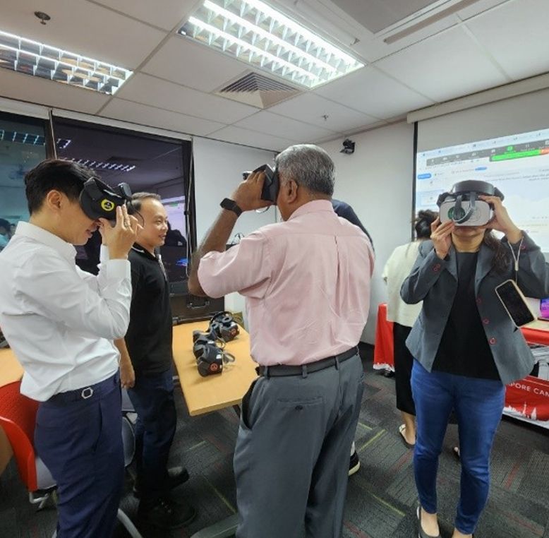 LSBF staff experiencing a virtual reality (VR) demonstration, gaining insights into how immersive technology will be used to enhance student engagement. The staff are seen wearing VR headsets and engaging with the technology as part of LSBF's innovative approach to education.