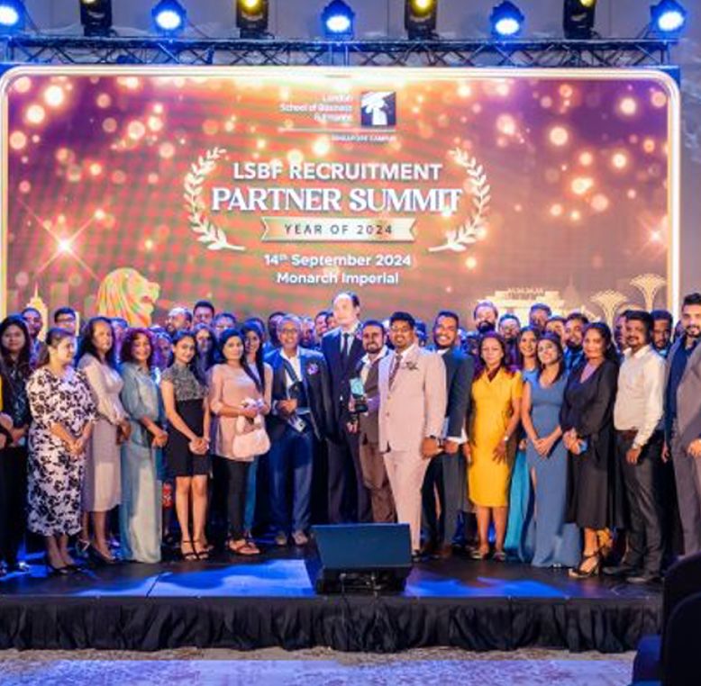 Group of people on a stage at the Summit