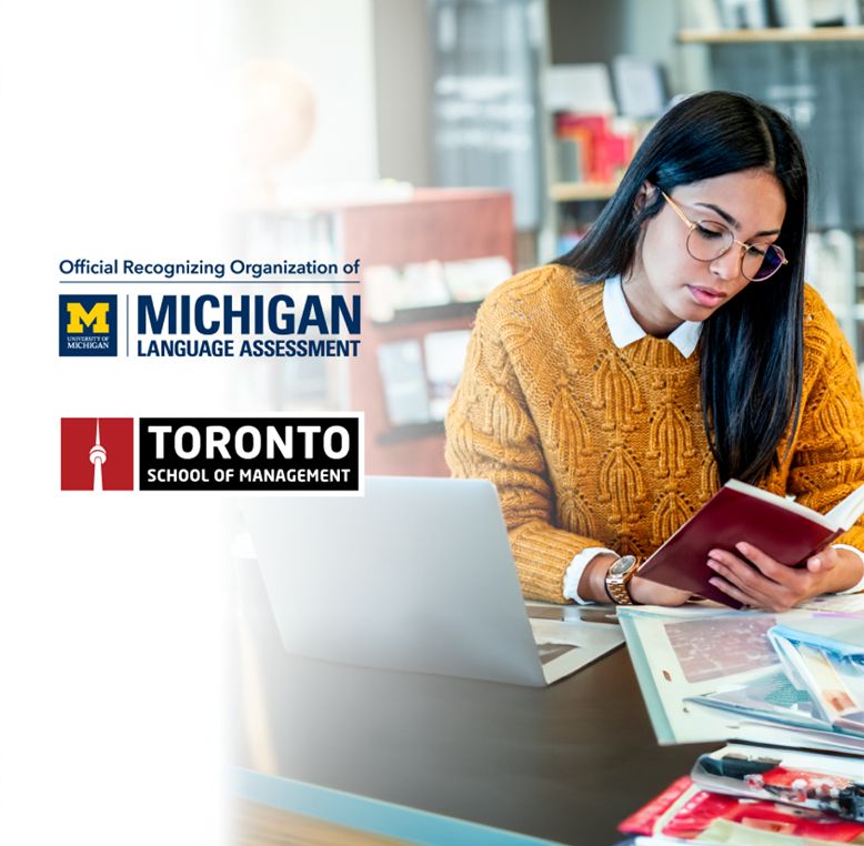 A woman in a yellow knit sweater and glasses sits at a desk, reading a book next to an open laptop. The image includes logos for the University of Michigan Language Assessment and Toronto School of Management in the top left corner.