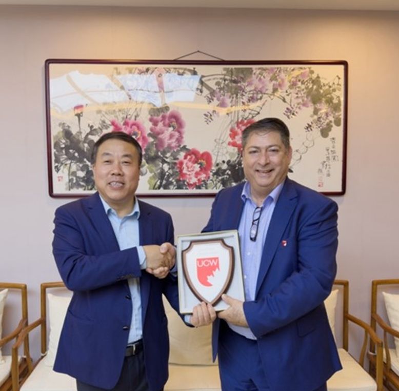 Dr Bashir Makhoul, President and Vice-Chancellor of University Canada West, and Dr Liu Lin, President of Beijing City University (BCU), shaking hands after signing a Memorandum of Understanding, formalising a partnership between the two institutions.