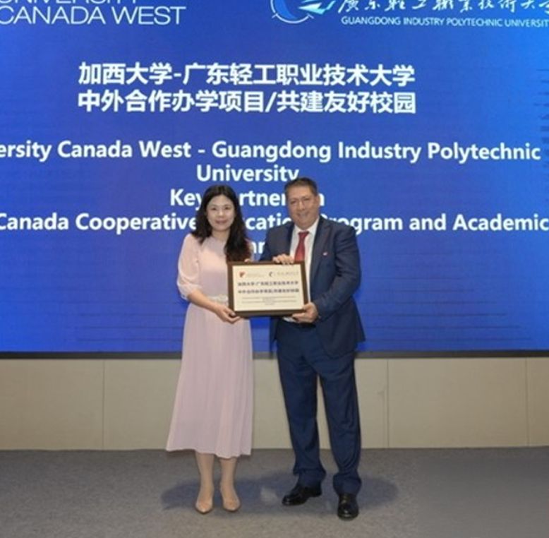 Two people holding a certificate