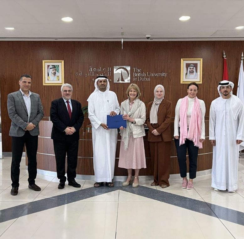 Agroup of delegates from The University of Law and British University of Dubai displaying an agreement.