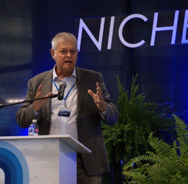 Dr David Gray, Provost and Vice-President, Academic at UNF talking to audience from a lectern.