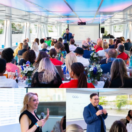 Corporate event on boat with speakers presenting to seated audience at decorated tables.