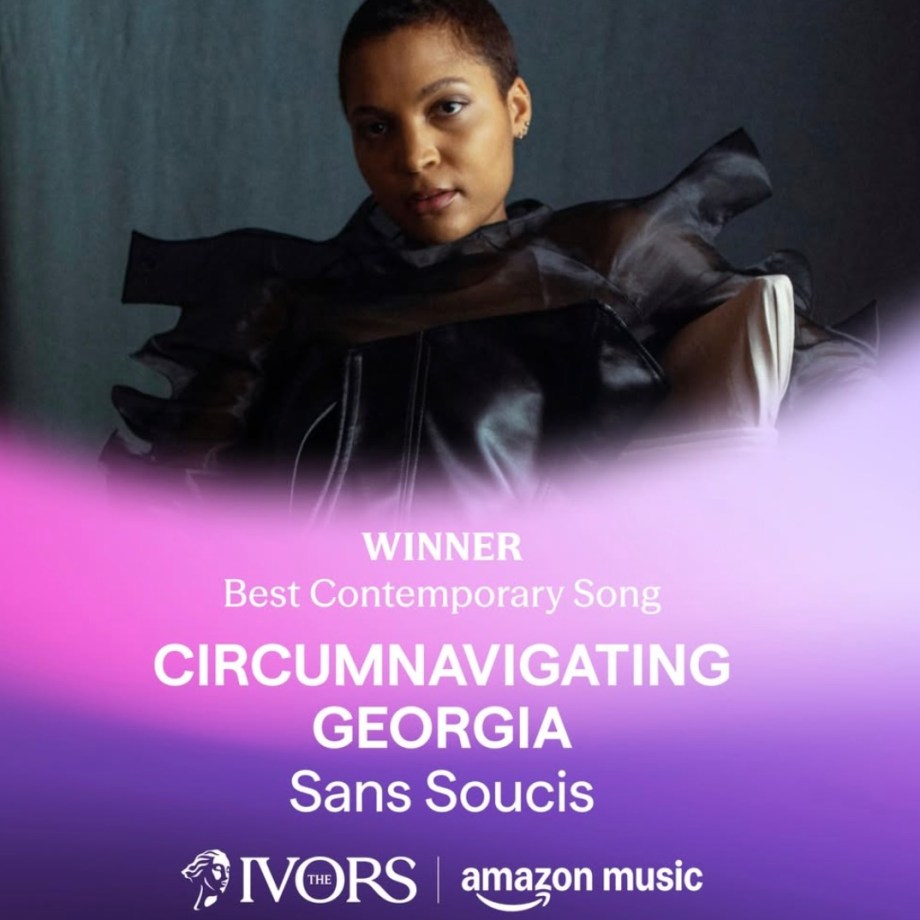 Singer in black outfit with dramatic bow details posing against purple gradient background for Ivor Novello Award announcement.