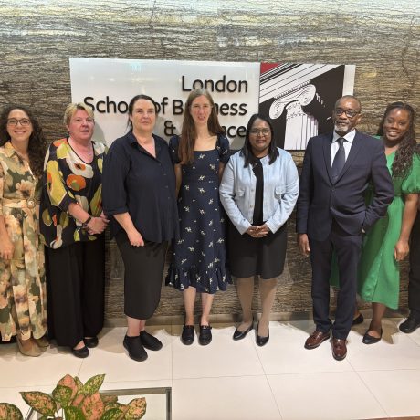 Group of professionals posing together at London School of Business & Finance Singapore campus.