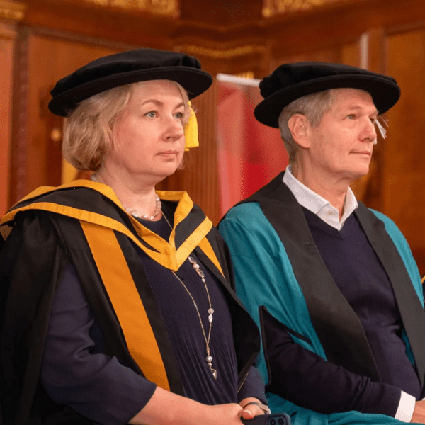 A students at a graduation ceremony wearing the cap and gown.