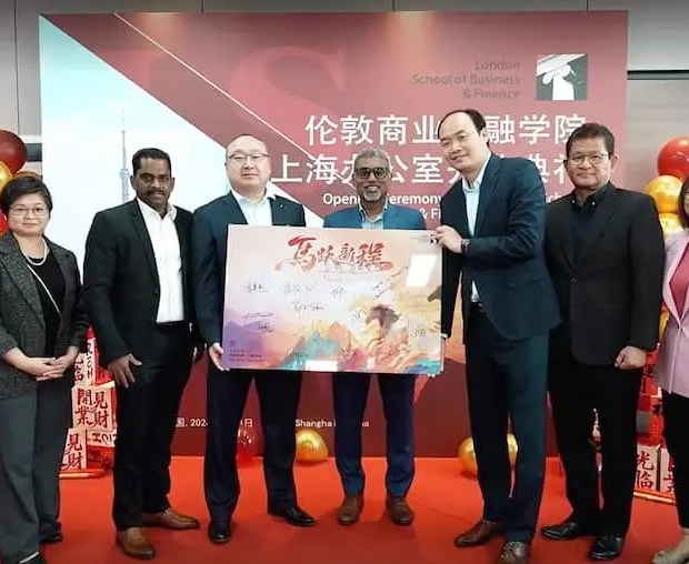 Group photo of representatives at the opening ceremony of the London School of Business and Finance Shanghai office, standing on a red-carpet stage with branded signage and celebratory decorations.