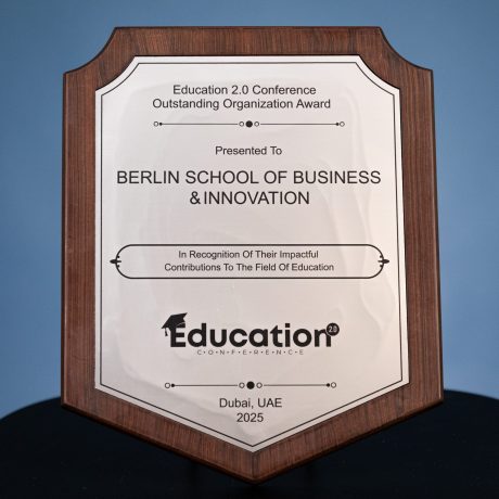 “Wooden award plaque presented to Berlin School of Business & Innovation at the Education 2.0 Conference for Outstanding Organization Award, recognizing impactful contributions to education, Dubai, UAE, 2025.