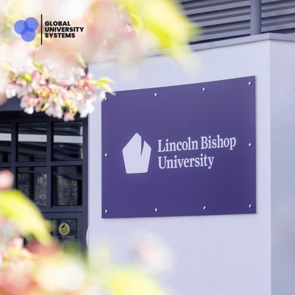 Lincoln Bishop University sign on campus, with the Global University Systems logo displayed in the top left.