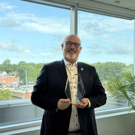 University of Niagara Falls Canada representative holding a Corporate Vision award.