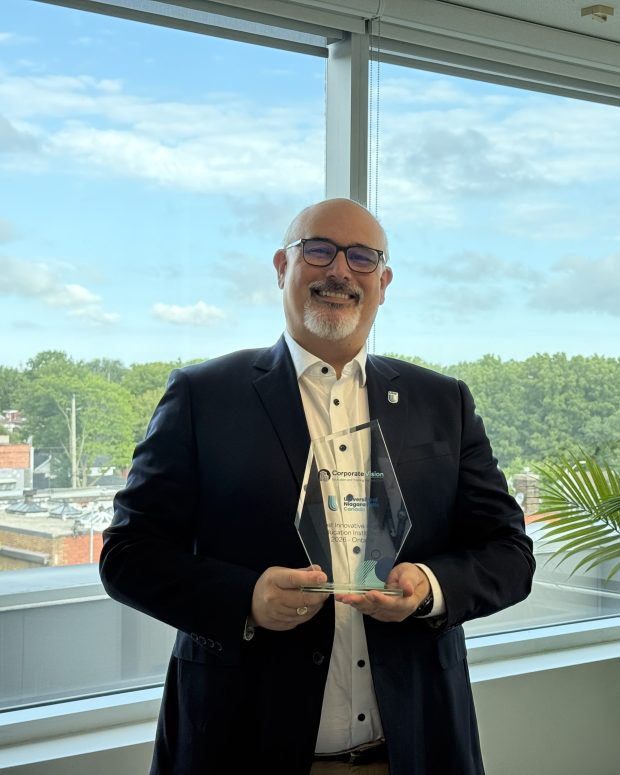 University of Niagara Falls Canada representative holding a Corporate Vision award.