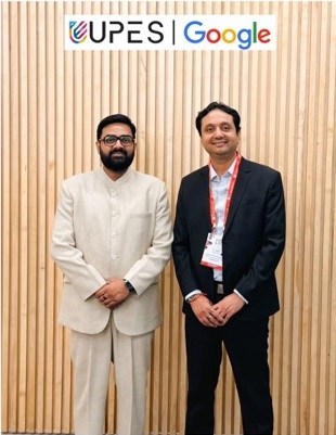 Two men standing beneath UPES and Google logos.